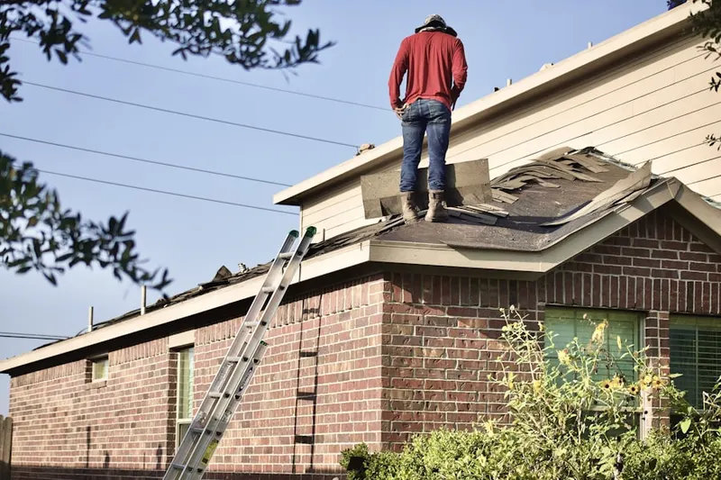 Professional roofer working on a residential roof in Downtown Auburn